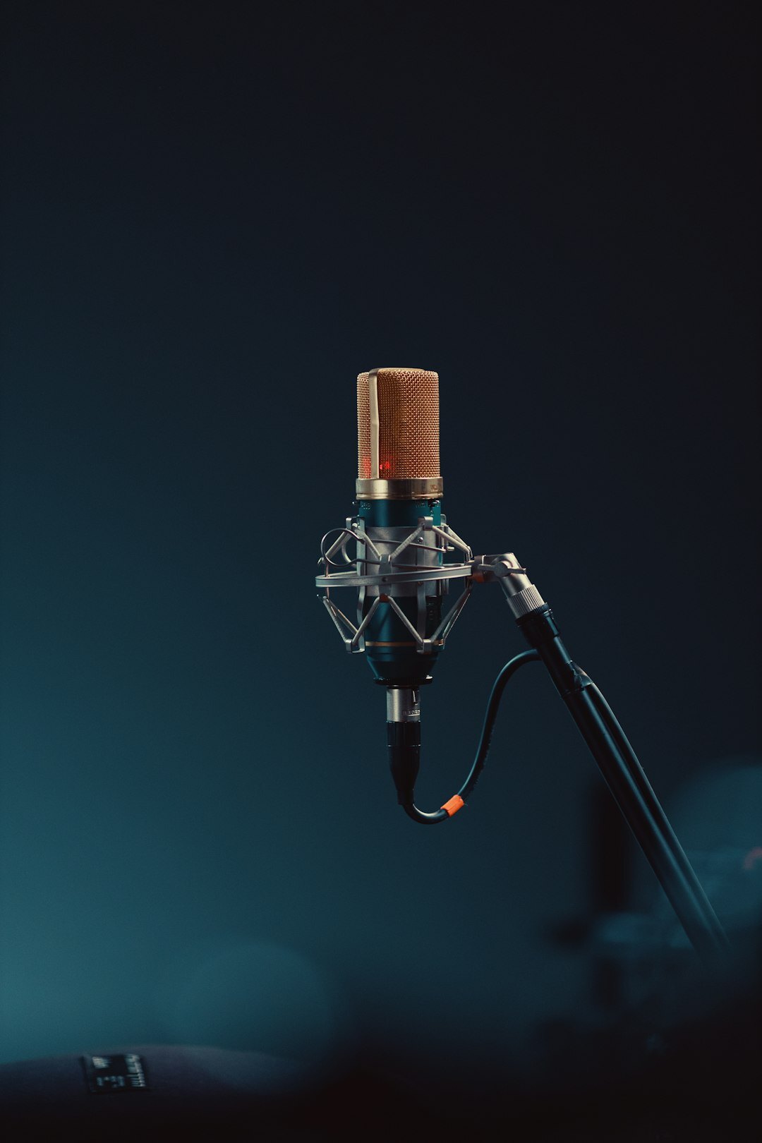 Interviewer with headphones speaking into a microphone in a professional recording studio